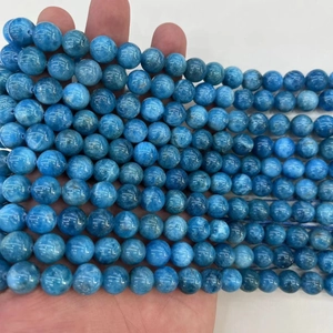 Natural round blue lapis lazuli loose beads for DIY jewelry held in a palm