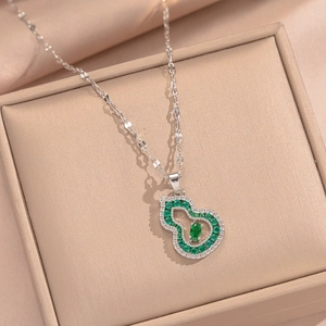 18K gold plated Wu Lou necklace with green zircon inlay on jewelry box display