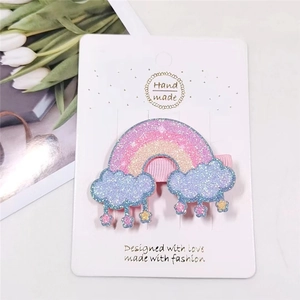 Close-up of glitter rainbow and cloud hair clip for girls with hanging star charms