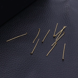 Flat head gold stainless steel pins for DIY earring making on black leather texture