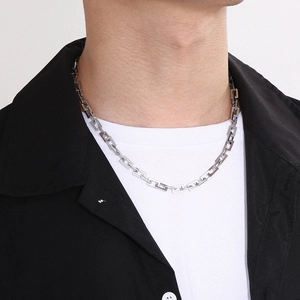 Close-up of a silver titanium steel men's chain necklace with rectangular links