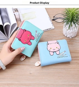 Detail of mint green and blue cat wallets with cute ear flaps and metal zipper charms