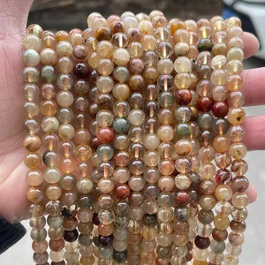 Close-up of natural colorful rutilated quartz beads showing internal needle structures