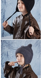 Detail of warm winter knit hats for kids featuring ear flaps and cute cartoon cat ears