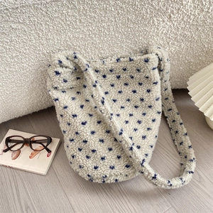 Detail of soft faux fur tote bag with blue polka dots and wide shoulder strap