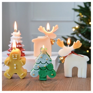 Detailed view of handcrafted gingerbread man, Christmas tree and reindeer shaped candles