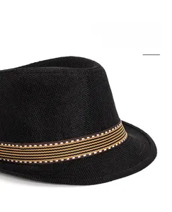 Detail of black woven fedora sun hat with a striped band and wide brim design