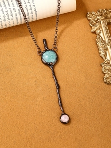 Detailed shot of retro bohemian sword pendant with amazonite and rose quartz stone