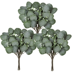 Three artificial eucalyptus branches with small white flowers on a white background
