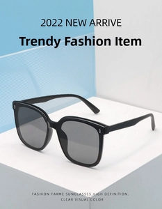 Detail of square black sunglasses with silver rivet accents and polarized lenses