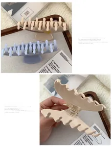 Detail of wavy acetate hair claws with premium matte finish and inner metal spring