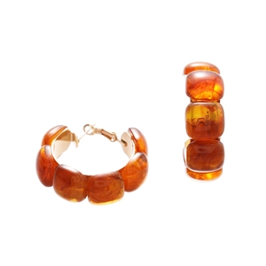 Maillard style amber resin geometric hoop earrings with golden metal clasps on white background