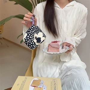 Mini floral storage bag with black polka dots and a white 3D flower charm detail