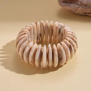 Detailed close-up of bohemian acrylic geometric bracelet with marble texture beads