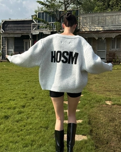 Cardigan grigio oversize in maglia con scritta nera HOSM sul retro, scatto all'aperto