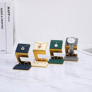 L-shaped jewelry display set in gold metal with velvet pads for rings and watches