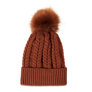 Close-up of caramel cable knit beanie featuring a thick ribbed cuff and large pom-pom