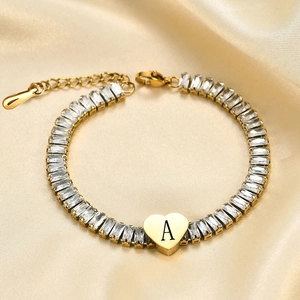 Golden heart bracelet with white zircon and letter A charm on yellow satin
