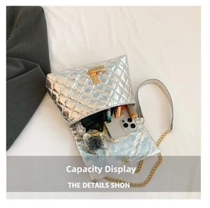 Detail showing internal capacity of silver quilted chain bag with phone and sunglasses