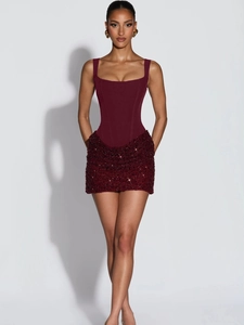 Close-up of burgundy corset dress featuring sequined fabric texture and structured bodice