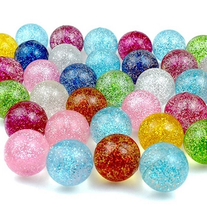 Close-up of vibrant glittery bouncy balls in multiple colors for gashapon machines