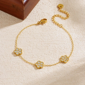 Bracelet élégant en acier inoxydable doré avec trois pendentifs fleurs en zircon blanc