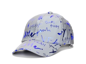 Macro detail of glowing reflective fabric on baseball cap with blue graffiti print