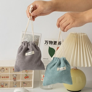 Detail of grey and blue corduroy drawstring pouches showing soft texture and cotton rope
