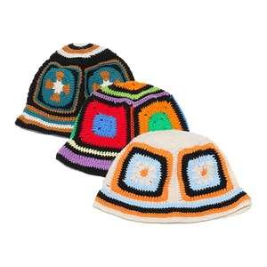 Detailed view of three colorful handmade crochet bucket hats with floral knit patterns