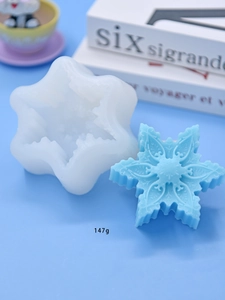 Detailed snowflake silicone mold for DIY baking and crafts with a 147g blue resin cast