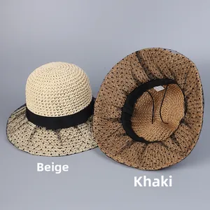 Detail view of woven straw hats in beige and khaki with lace trim and bow ribbons