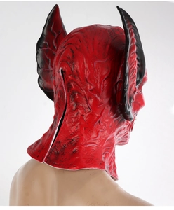 Detail view of red monster mask featuring large black ears and a rear slit for wearing