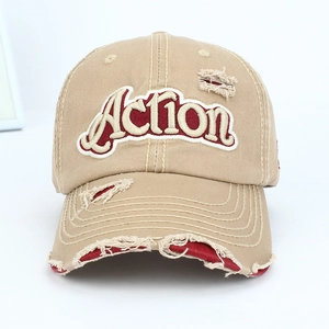 Detail of vintage distressed baseball cap with embroidered Action logo and worn edges