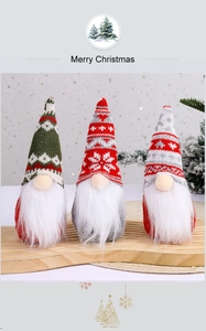 Close-up of three Christmas gnomes with knitted snowflake hats and long white beards