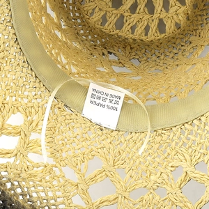 Detail shot of internal 100% paper material label and sweatband on straw cowboy hat