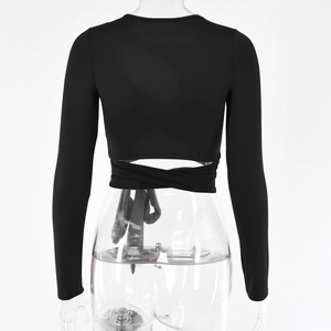 Detailansicht eines schwarzen langärmeligen Crop Tops mit Cut-Out-Design und Taillenbändern