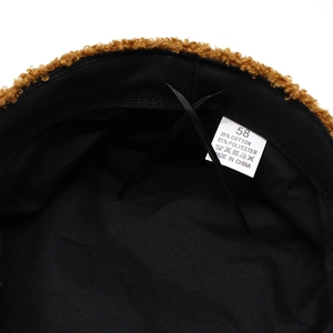 Detail of brown lamb wool hat interior with adjustable drawstring and size label