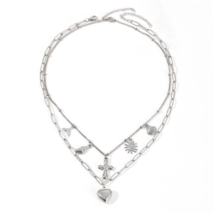 Silver double layer necklace featuring cross heart and shell pendants on a white background
