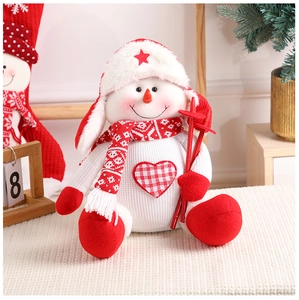 Close-up of a Christmas snowman plush doll with knitted hat and heart pattern detail