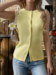 Close-up of pale yellow sleeveless knit vest with single-breasted front buttons