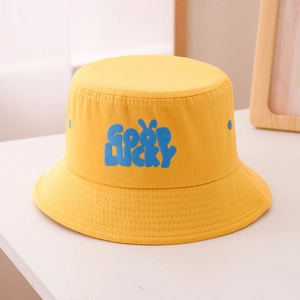 Detail of yellow cotton bucket hat with blue GOOD LUCKY embroidery and reinforced brim stitching