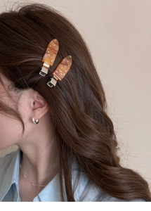 Detailed macro view of amber resin hair clips with sparkling colorful crystal rhinestones