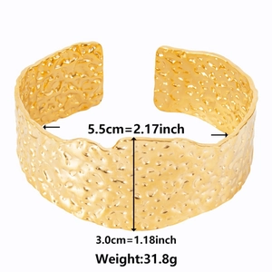 Gold wide cuff stainless steel bangle with irregular hammered texture and open design
