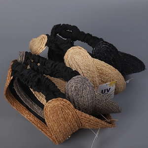 Detailed top view of Raffia straw sun visors in various colors with UV care labels