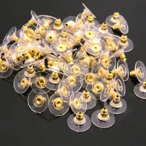 Golden bullet ear backings with transparent plastic disc pads for heavy earrings