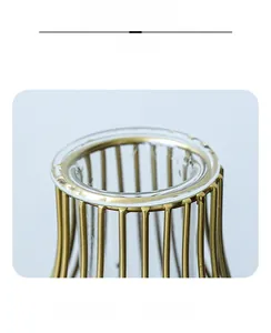 Macro detail of the European minimalist glass vase with golden metal lantern frame