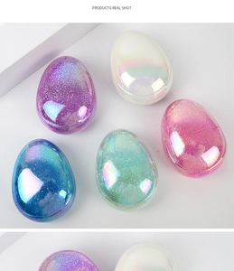 Detailed view of colorful egg-shaped detangling hairbrushes with sparkling glitter finish
