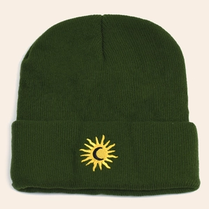 Dark green knitted beanie featuring sun and moon embroidery for autumn and winter style