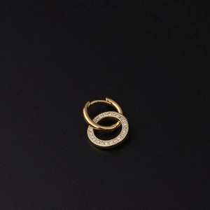 Detailed close-up of gold nested hoop earrings featuring sparkling pave cubic zirconia