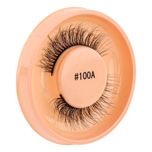 Detailed close-up of thick black self-adhesive false eyelashes in a round orange case